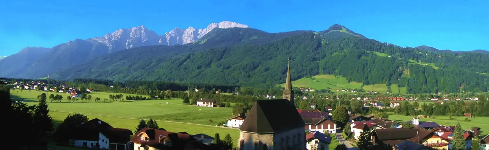 Unsere gotische Kirche hinunter ins Salzachtal, dahinter das Bergpanorama, besonders imposant das Massiv des Hohen Göll